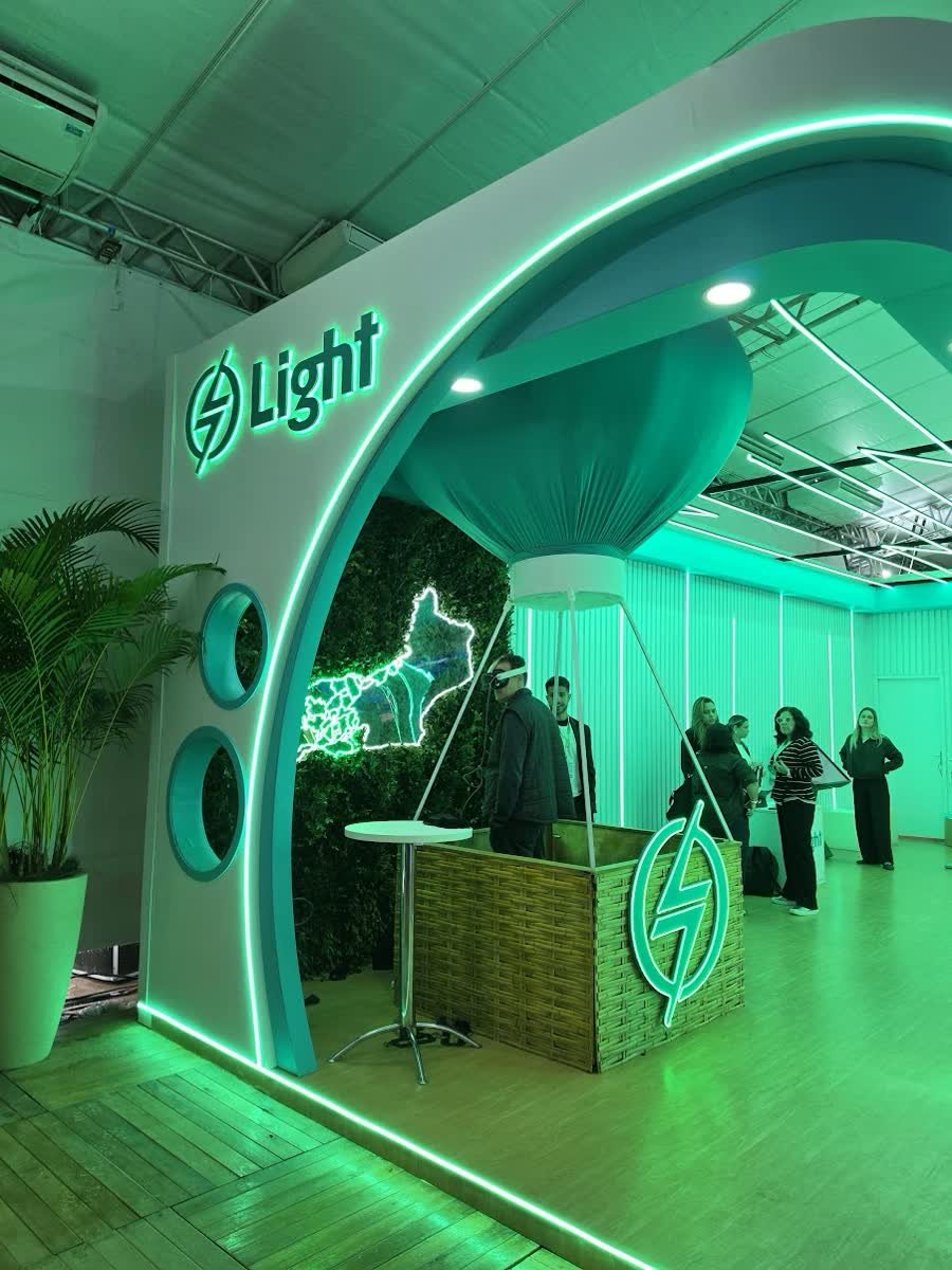 Light booth with an arch lit in neon green and a set-built hot air balloon at the center